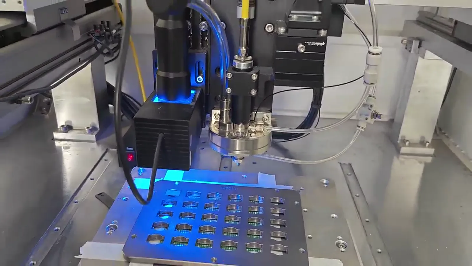 Supplied video frame of a precision soldering machine operating around a fixture