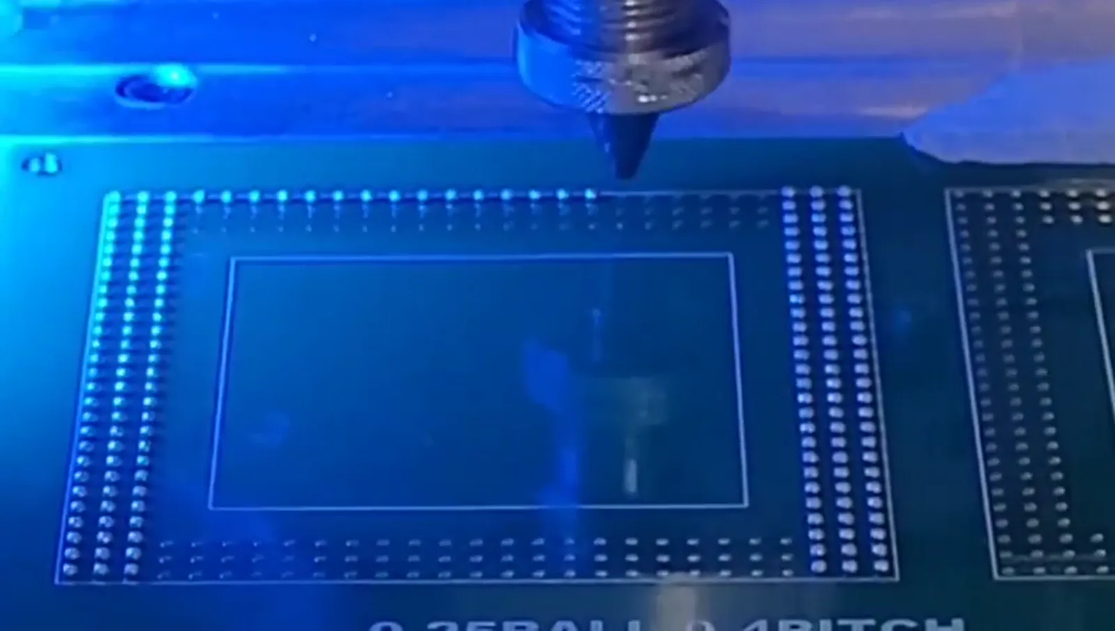 Supplied video frame of a jetting nozzle above an array processing test pattern